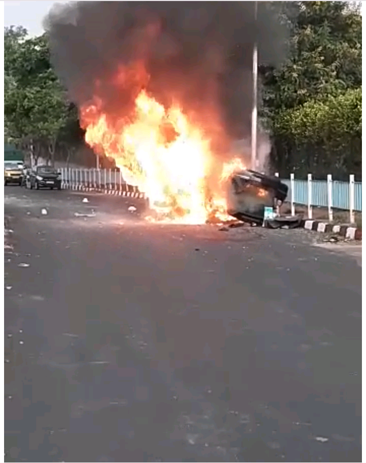 Car bursts into flames after hitting road divider