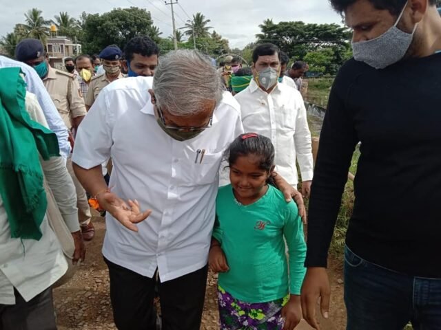 Education Minister Suresh Kumar interacting with one of the child.