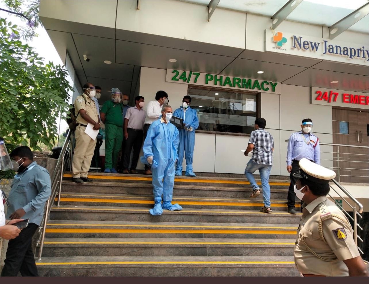 IAS Manivannan and IPS Alok Kumar in PPE kit outside New janapriya hospital
