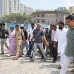Krishna Byre Gowda inspecting an uneven road with officials and police in east Bengaluru.