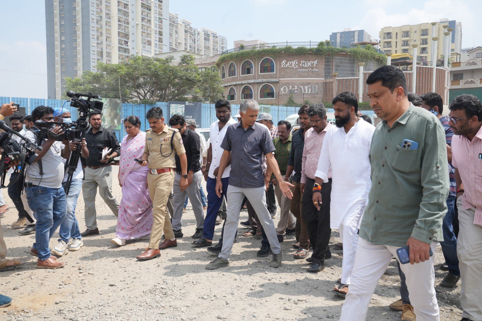 Krishna Byre Gowda inspecting an uneven road with officials and police in east Bengaluru.