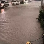 Cars, an auto-rickshaw and a bus on a waterlogged Bengaluru road in a video shared by Bellandur Traffic Police.