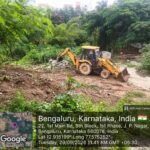 Earthmoving machinery at the land clearance site opposite Banashankari temple