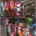 Workers clearing drainage beside vehicles on a waterlogged road at Kundalahalli Colony in Garudacharpalya