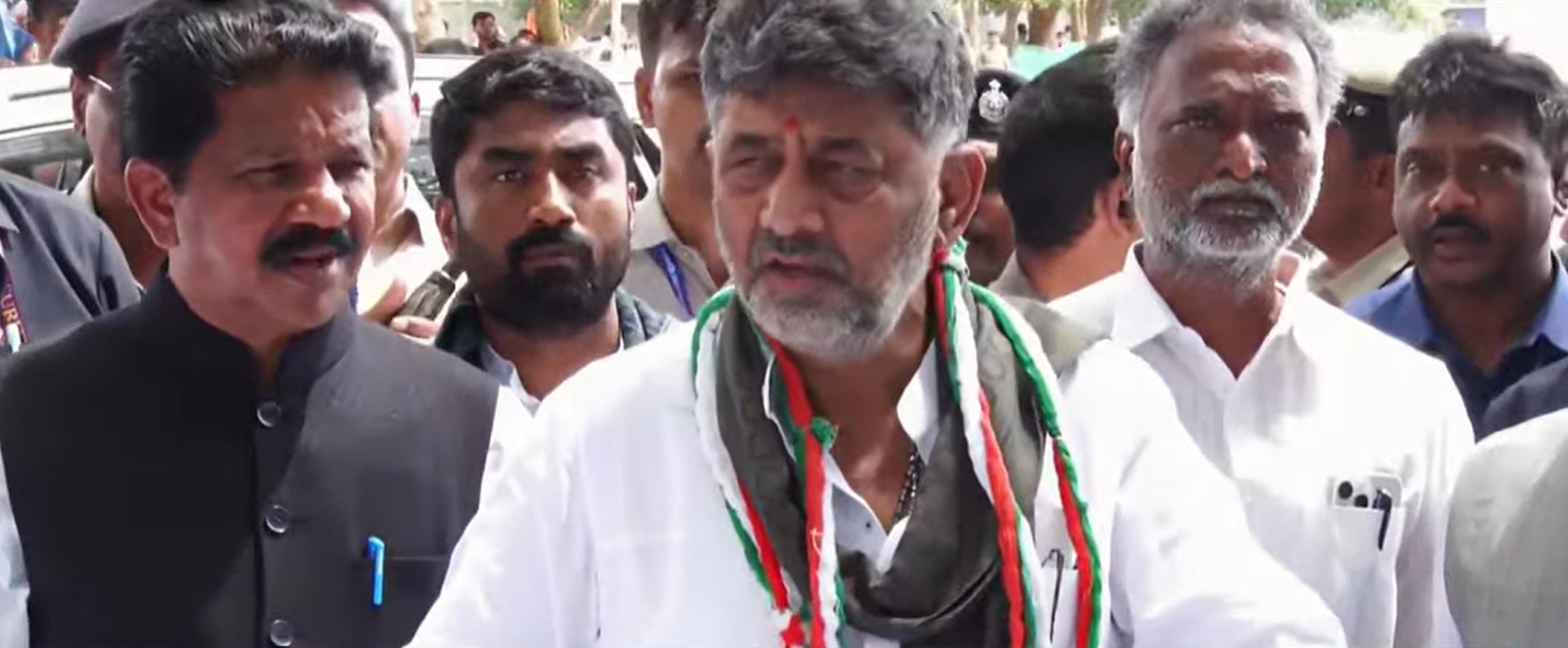 D K Shivakumar speaks to reporters near Sirigere Mutt in Chitradurga
