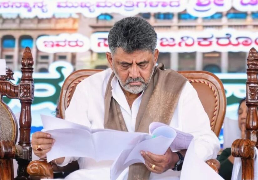 Chief Minister D.K. Shivakumar reviews documents at the Kasturirangan report public consultation in Sakleshpur