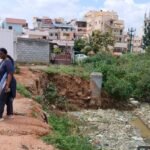 Officials beside a stormwater drain during a Bengaluru East drainage inspection