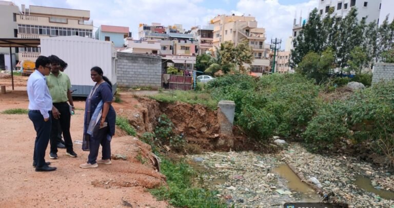 Officials beside a stormwater drain during a Bengaluru East drainage inspection