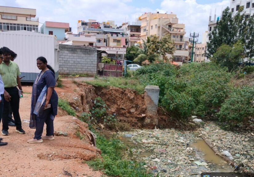Officials beside a stormwater drain during a Bengaluru East drainage inspection