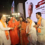 Amit Shah lights a ceremonial lamp with other participants at the Ashok Singhal birth centenary event at Bharat Mandapam