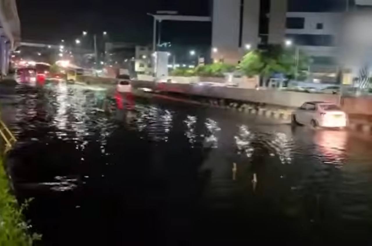 Vehicles on a waterlogged road at night