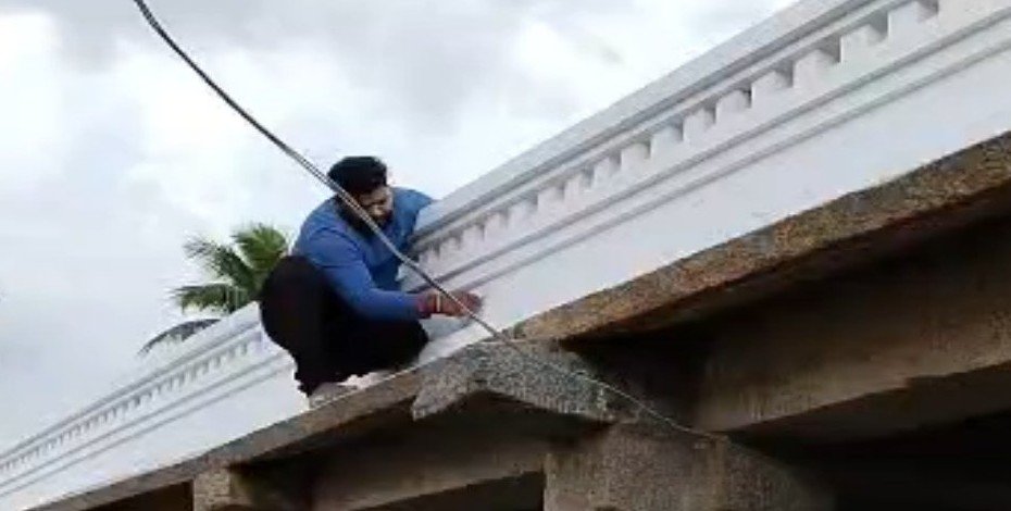 A man paints the temple wall in a photograph released by Mysuru district police