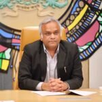 Priyank Kharge seated at his desk