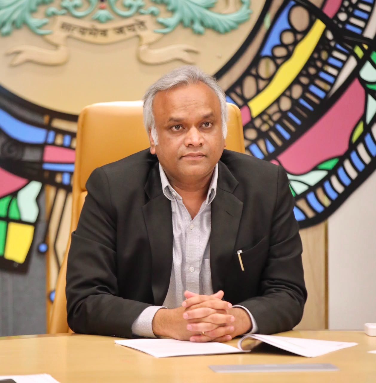 Priyank Kharge seated at his desk