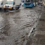 Vehicles move through waterlogging near Kasturi Nagar down-ramp toward Tin Factory in Bengaluru