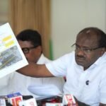 H D Kumaraswamy displaying a document at the Bengaluru NICE Road press conference