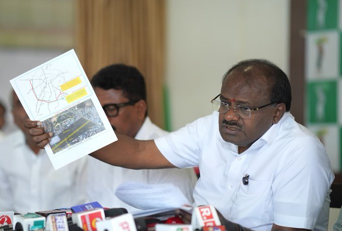H D Kumaraswamy displaying a document at the Bengaluru NICE Road press conference