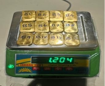 Twelve gold biscuits on a weighing scale in the Finance Ministry photograph of the Bengaluru airport seizure