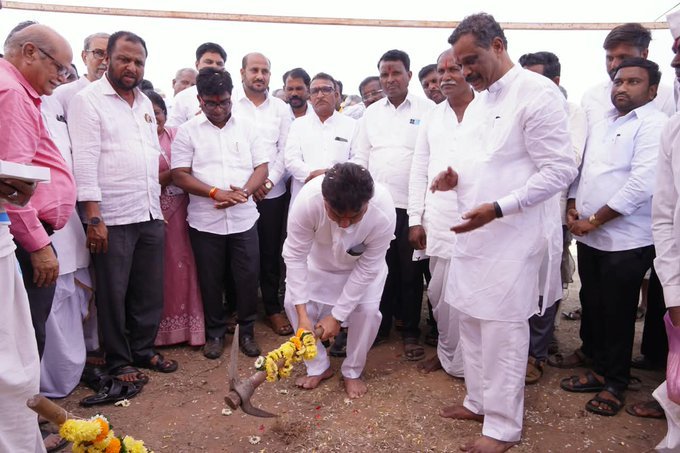 M B Patil performs bhoomipuje with a pickaxe at the Shegunasi residential school building site