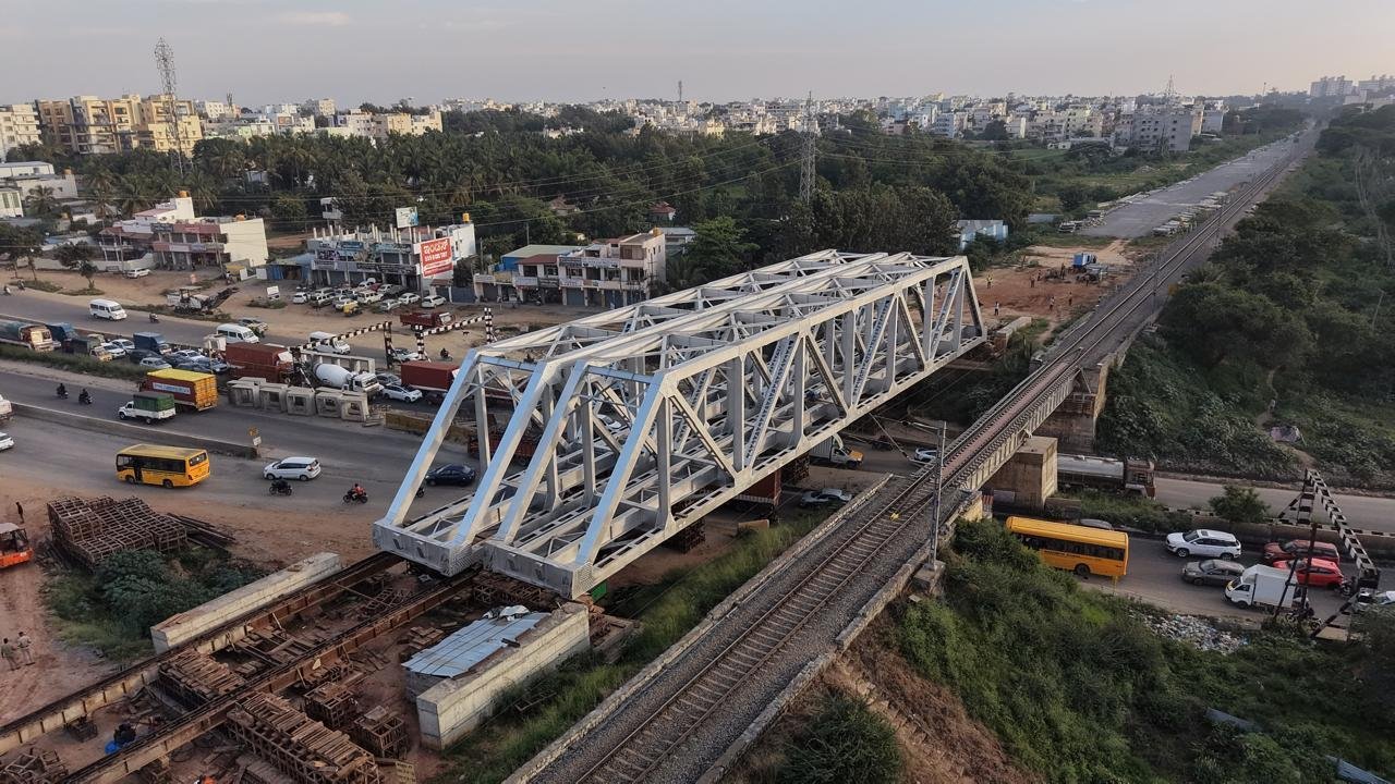 Aerial view of the new white railway bridge structure beside the existing bridge over NH-44 near Chandapura
