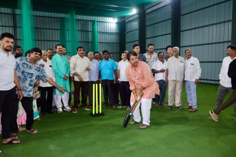 R Ashoka holds a cricket bat inside the Netaji Subhash Chandra Bose Sports Complex in Jayanagar