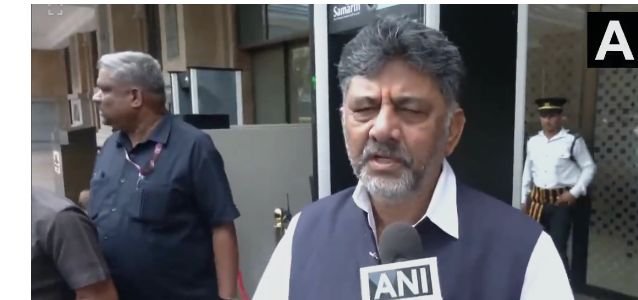 D K Shivakumar speaking to reporters.