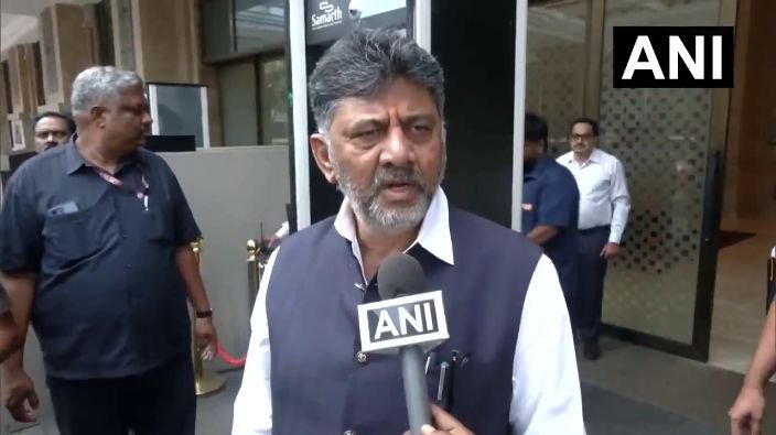 D K Shivakumar speaking to reporters.