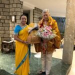 Umashree with Anant Nag, draped in a ceremonial shawl and holding flowers, at his residence
