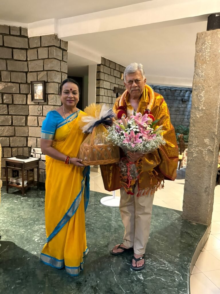 Umashree with Anant Nag, draped in a ceremonial shawl and holding flowers, at his residence