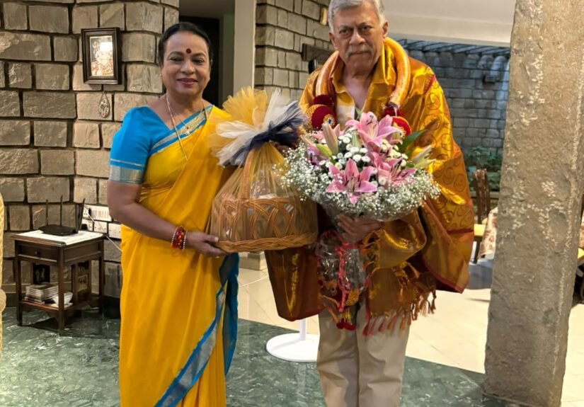 Umashree with Anant Nag, draped in a ceremonial shawl and holding flowers, at his residence