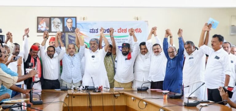 INDIA bloc leaders raise joined hands at a meeting in Bengaluru