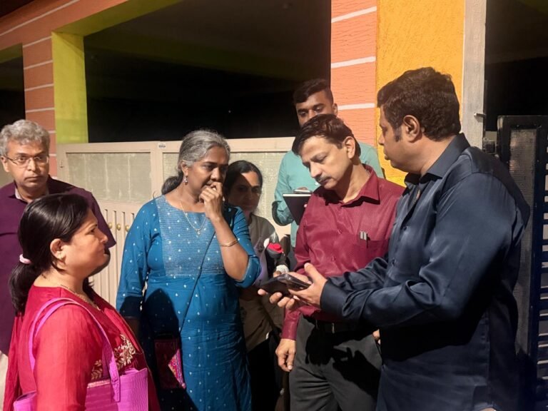 Officials speak with residents during an evening inspection