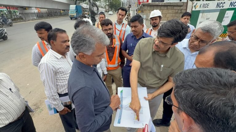 Krishna Byre Gowda and officials examine plans during a Bengaluru Metro site inspection
