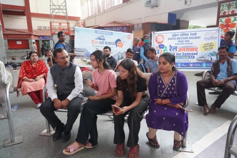 Railway official listens to passengers during Rail Jan Samvaad at a Bengaluru Division station