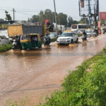 Vehicles pass through standing water at Kannuru junction towards Bagaluru Road in Bengaluru
