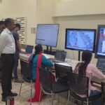 KEA officials monitor examination centres on screens in a control room