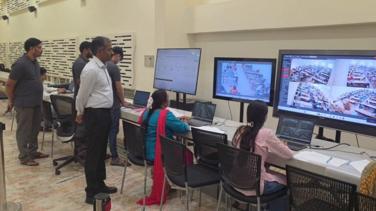 KEA officials monitor examination centres on screens in a control room
