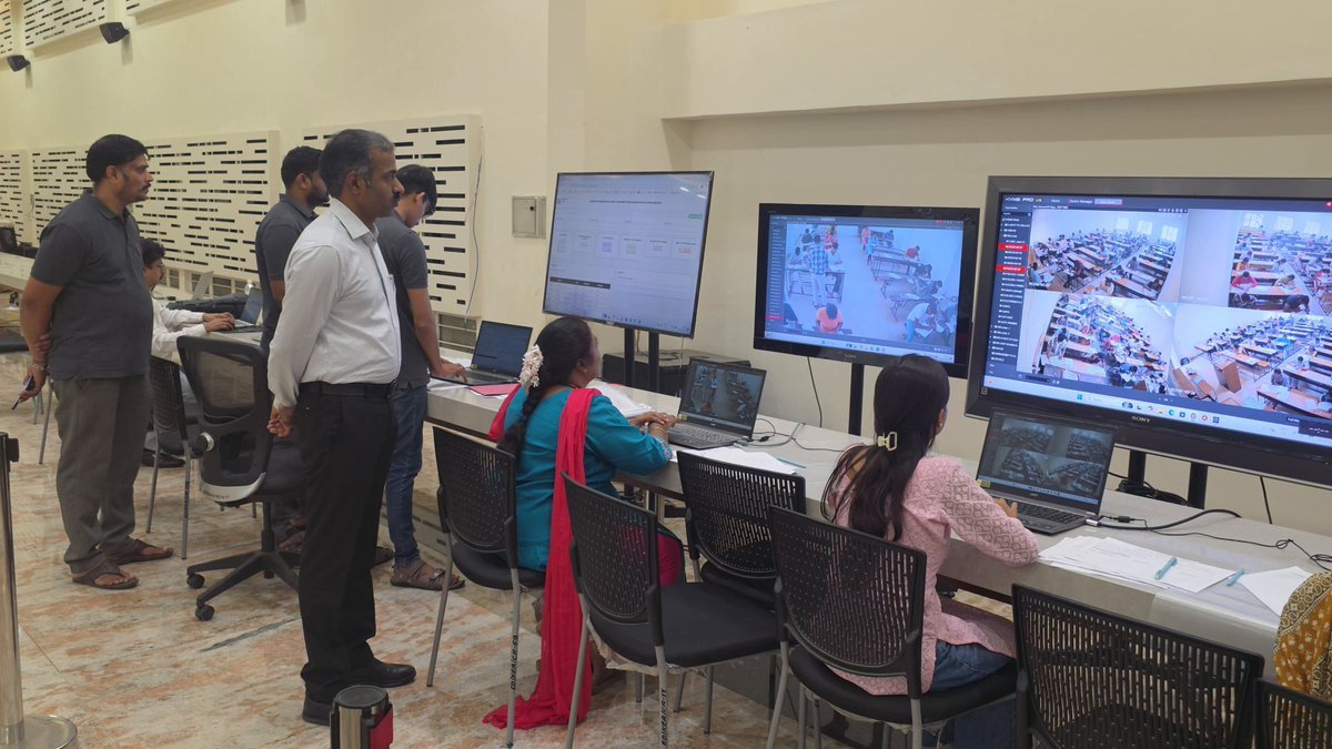 KEA officials monitor examination centres on screens in a control room