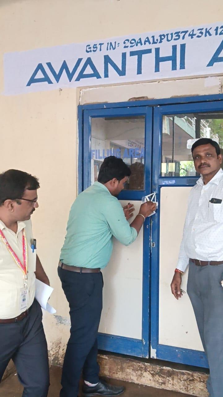 Officials sealing the entrance of a packaged drinking-water unit
