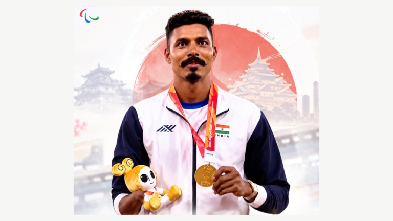 Nishad Kumar holding a gold medal and mascot, original SAI Bengaluru photo crop preserved in a landscape frame