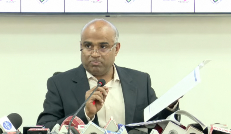 Karnataka Chief Electoral Officer V. Anbu Kumar holds a document while addressing the media in Bengaluru on October 27, 2026